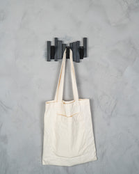 Modern Grid wall hooks holding a tote bag