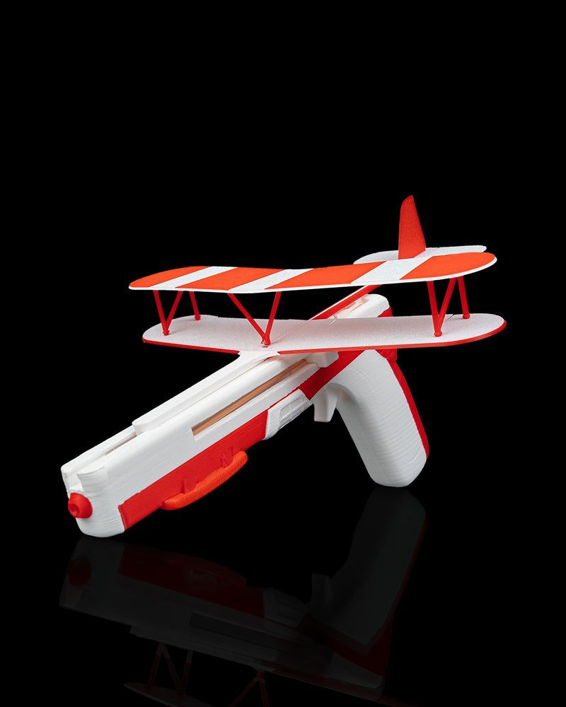 Red Baron red and white biplane glider on a stand