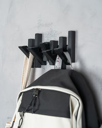 Modern Grid wall hooks holding a backpack