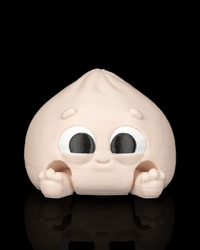 Cutie Dumplin clicker fidget toy with a cheerful face