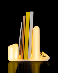 Glow Arc lit book and glasses holder on a nightstand