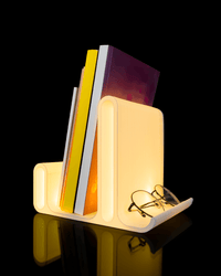 Glow Arc holding books upright with a warm glow