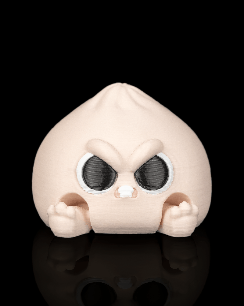 Grumpy Dumplin clicker fidget toy with an angry face