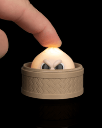 Finger pressing the grumpy dumpling clicker