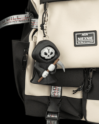 Moody Reaper clipped to a bag as a keychain