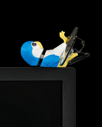 Perchmate bird glasses holder perched on a monitor with glasses