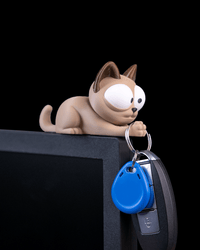 Purrsonal Assistant cat key holder draped over a desk edge