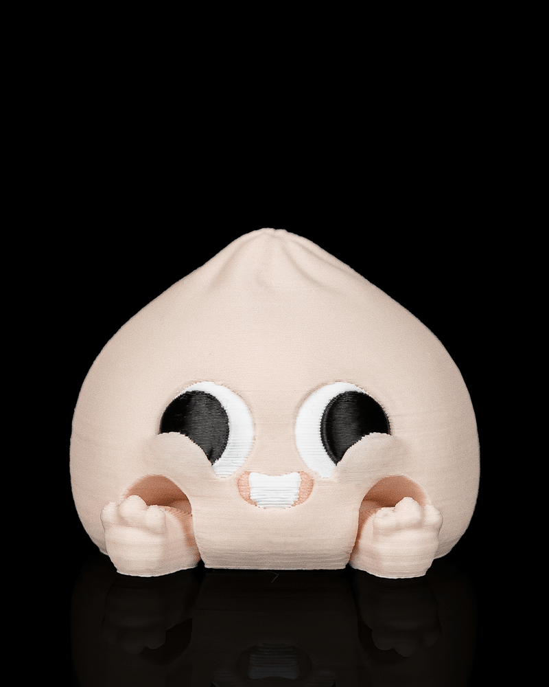 Smiley Dumplin clicker fidget toy with a happy face