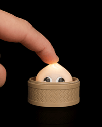 Finger pressing the smiley dumpling clicker