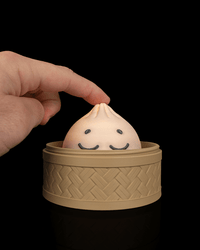 Finger pressing the snoozy mega dumpling clicker