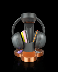 Tower Trio headphone stand with phone and pens on a copper base