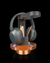Headphone stand holding pens and a phone